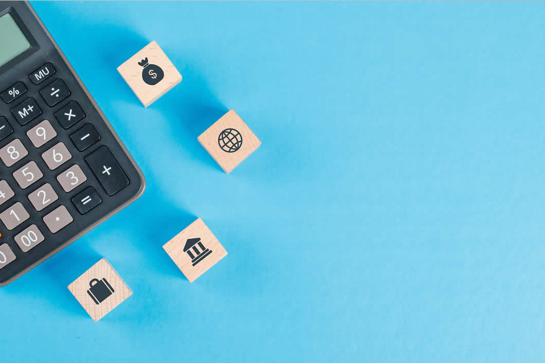 financial-concept-with-icons-wooden-cubes-calculator-blue-table-flat-lay